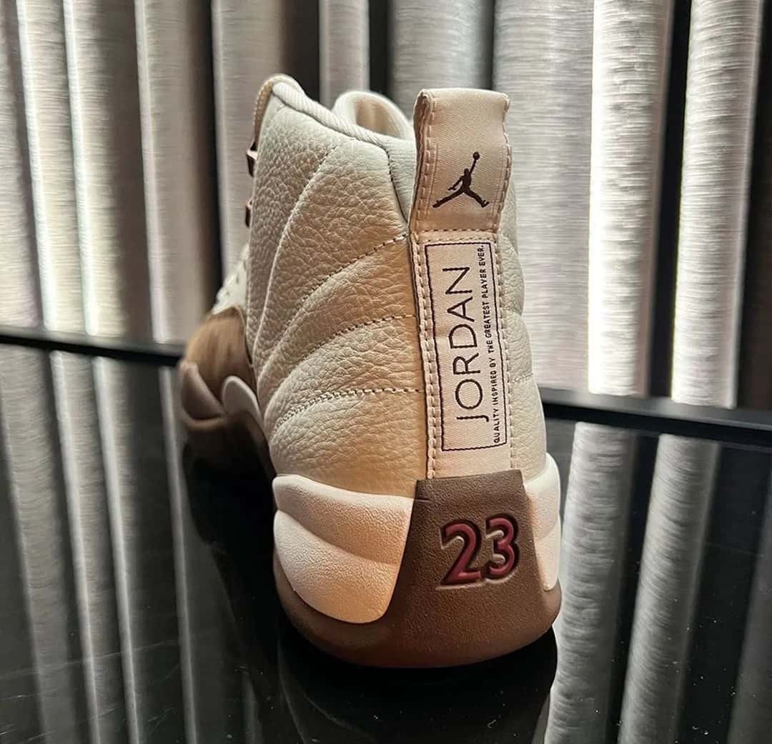 Talón del Air Jordan 12 Fireside con el tirador claro, la etiqueta Jordan y el 23 en rojo sobre la base marrón
