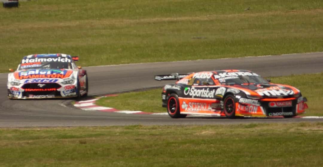 Foto de archivo: el Chevrolet Camaro negro y naranja de Agustín Canapino sale de una curva por delante de un Ford Mustang blanco