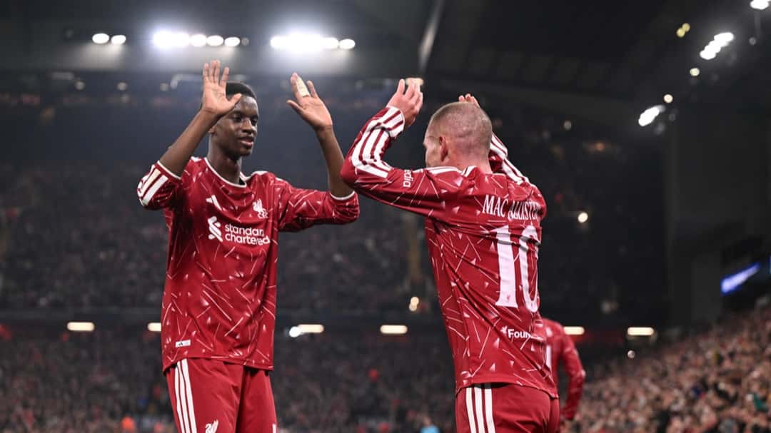 Alexis Mac Allister, con la camiseta roja del Liverpool y el número 10, choca las manos con un compañero para festejar en Anfield, con las tribunas llenas y las luces del estadio de fondo (foto: Liverpool FC)