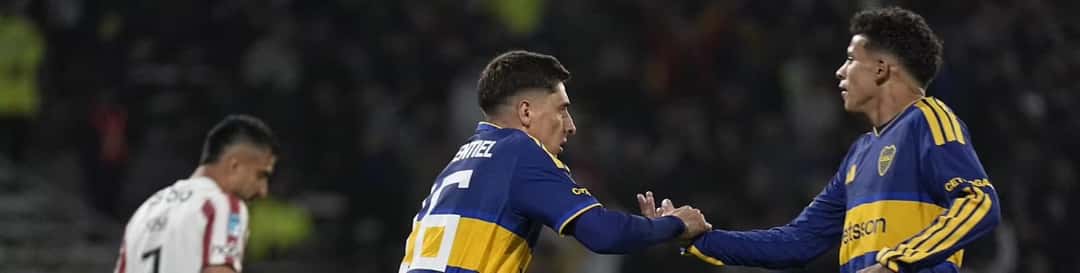 Miguel Merentiel, con la camiseta azul y oro de Boca, choca las manos con un compañero durante el empate ante Instituto en el Kempes (foto: prensa Boca Juniors)