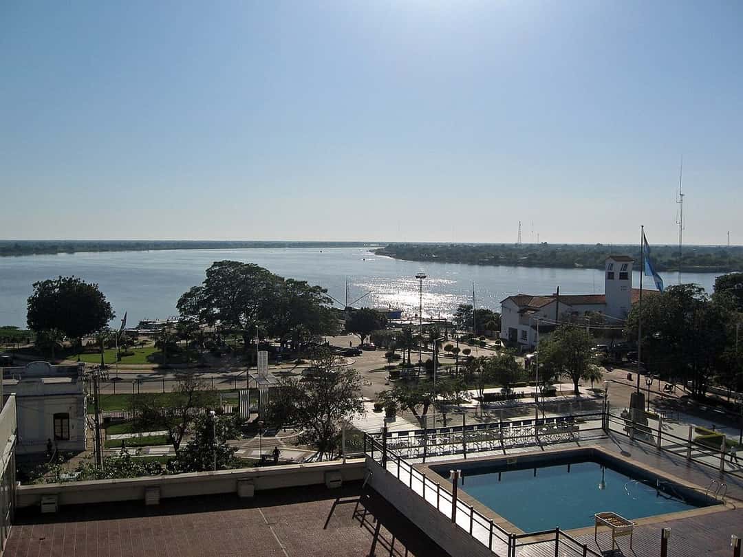 Vista del río Paraguay desde la ciudad de Formosa, con la costanera, árboles y un edificio con una bandera argentina; foto de archivo de 2009 (foto: Silviaanac, Wikimedia Commons, licencia CC BY-SA 4.0)