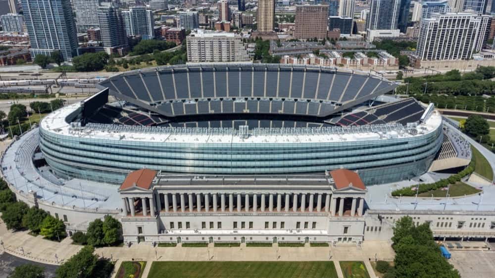 Vista aérea del Soldier Field de Chicago, con su tribuna curva y la fachada de columnas, rodeado de edificios y árboles. Foto: Sea Cow, CC BY-SA 4.0, vía Wikimedia Commons